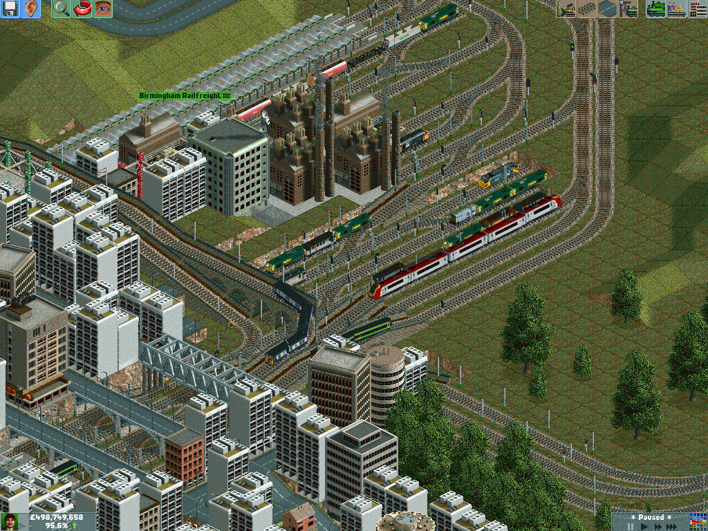 A Virgin Voyager leaves Birmingham bound for Tamworth and the North, as a Central Trains 158 from Nuneaton and an EMU from Lichfield enter Proof House Junction. The Freightliner terminal can be seen as well.