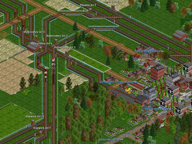 An overview of Rylesvalley Jct with three trains on the move: just south of the junction there is the 4-6-0 #234 with an empty stock train on route 902-F while on the adiacent track her sister #232 is heading a passenger train on route 903. In the northwestern corner is coming #237 with a goods train on route 901-G.