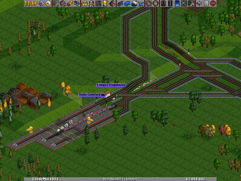 In response to the new train that I made that is 8 squares long and the inherent difficulties with the old station, I completely relocated the station.  Doing this also required a facelift of the surrounding tracks. I consider this an improvement, for the most part.  The 8 square-long train is coming from Haveno de Peswich, since the new canal (see next) has given me the ability to access more forests by ship.