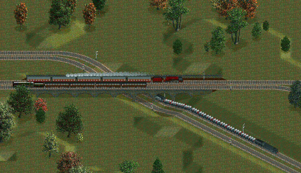 Two expresses pass over a steel train on the freight line below.