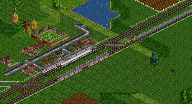 XP2005 waits at a small station for an approaching coal train to pass
