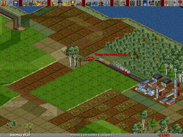A 'Midlander' Steam loco approaches the thing-that-looks-like-a-farm-but-is-actually-a-sugar-mill, ready to load up.
