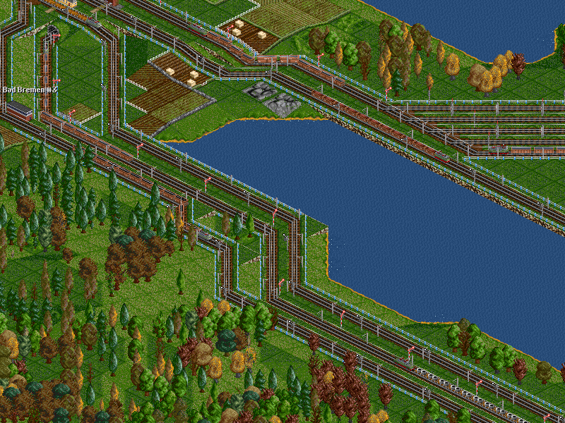 That train has now reached the foot of the mountain that separates it from the power station. Below us are the steel trains' tracks, and on the other side of the lake lie the exit tracks of the steel mill.