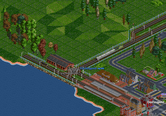 A GG1 heads out with a streamlined consist.  Some boxcabs can be seen next to the train shed.