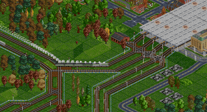 A streamlined 4-6-4 can be seen rolling into the station here.