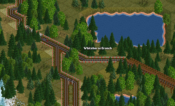 4-6-0 and passenger train at Whitehorse Junction.  The line heading right over the bridge leads to the mine, the left track leads to the town itself.